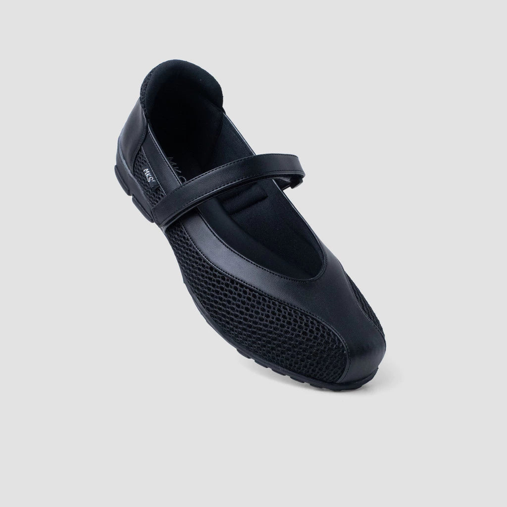 A black flat shoes by MKS Shoes with a Mary Jane strap and a low heel, set on a white background.