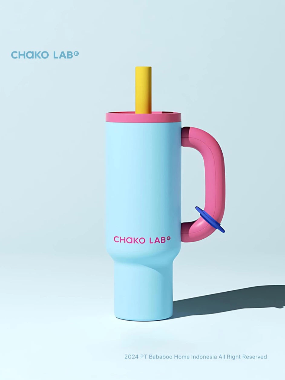 Colorful Chako Lab tumbler with handle and straw on a light blue background.