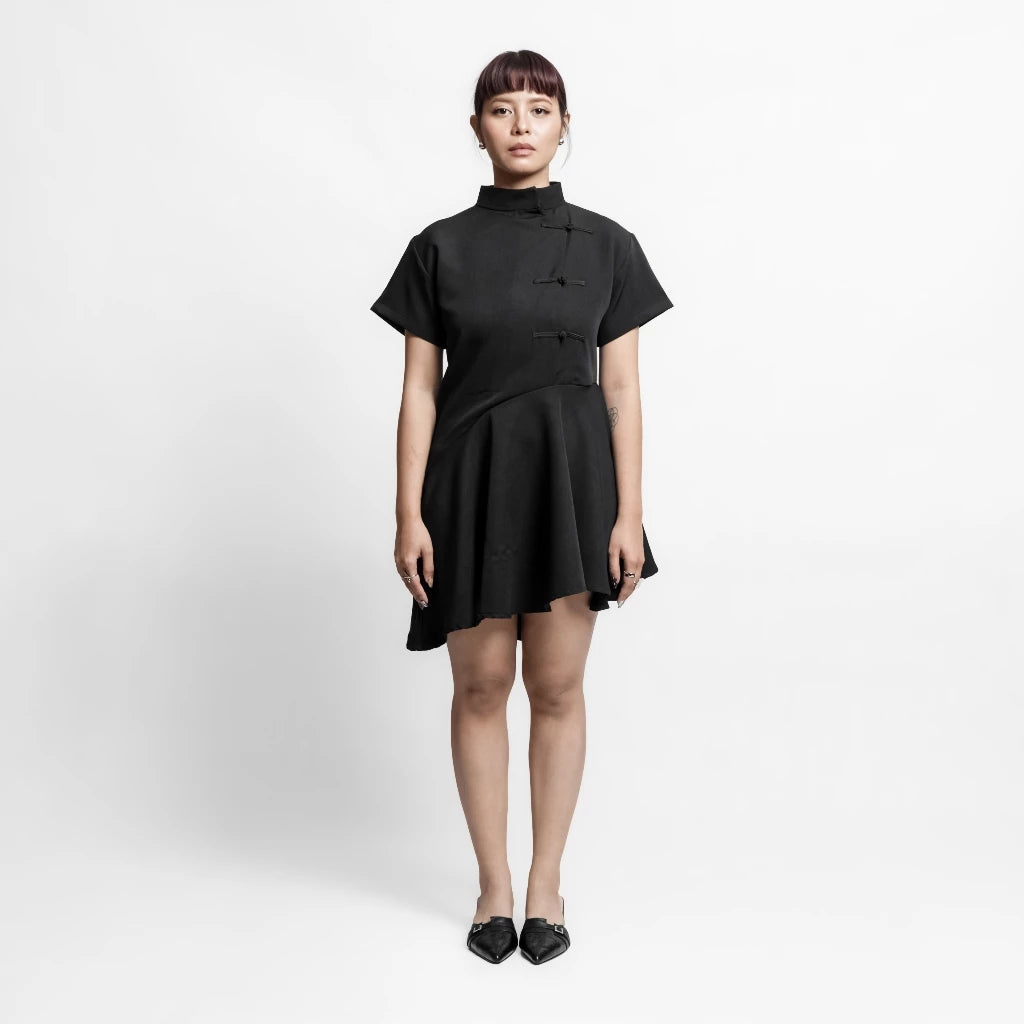 Person wearing a black midi dress by Isoos Studios on a white background