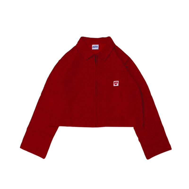 A red crop jacket with a collar, long sleeves, and a front pocket, featuring a small red logo on the chest by notyourcompany.