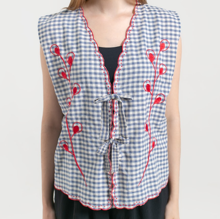 A closer look of blue and white checkered vest with red embroidery named Embro Vest from Saya Saya on a plain background