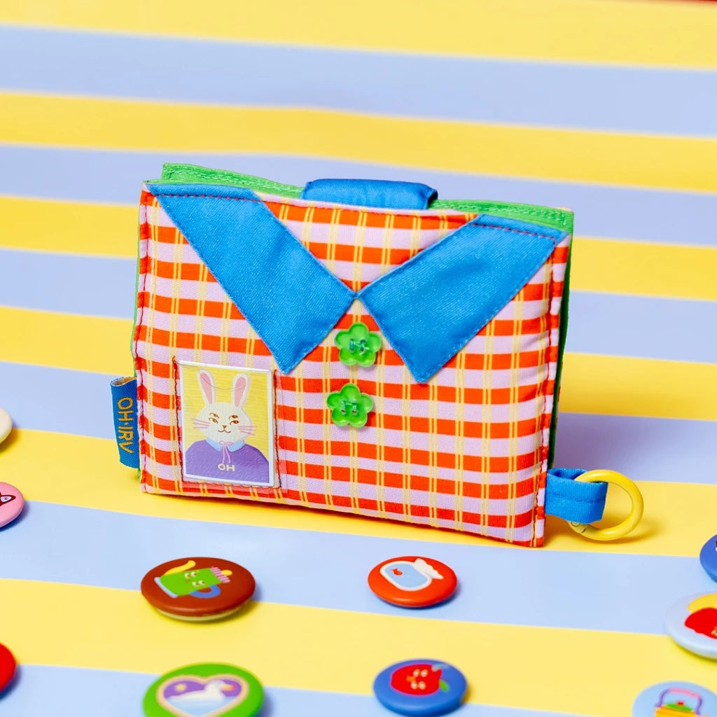 Colorful wallet by Oh.Irv with a checkered cover on a striped background