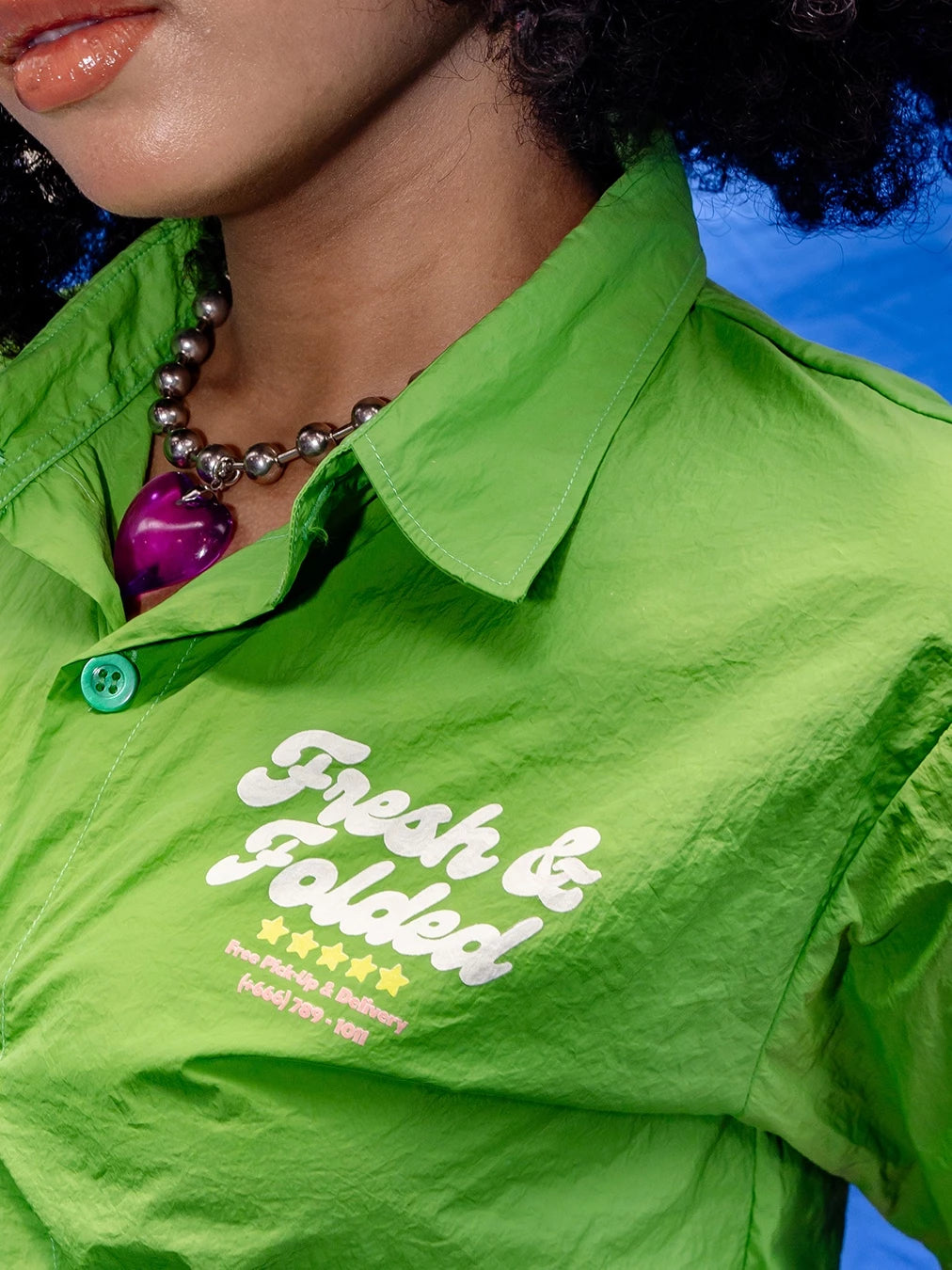 Green workshirt by Oh.Irv with 'Fresh & Folded' text worn by a person.