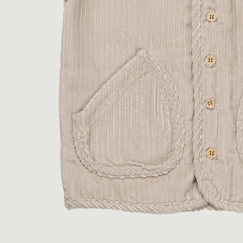 Close-up of a Camma Vest with a pocket and buttons on a light gray background