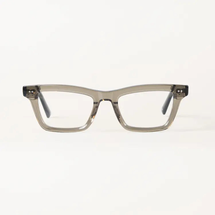 A pair of square-frame eyeglasses by Heykama with translucent smoky gray acetate frames and clear lenses, shown against a plain white background.