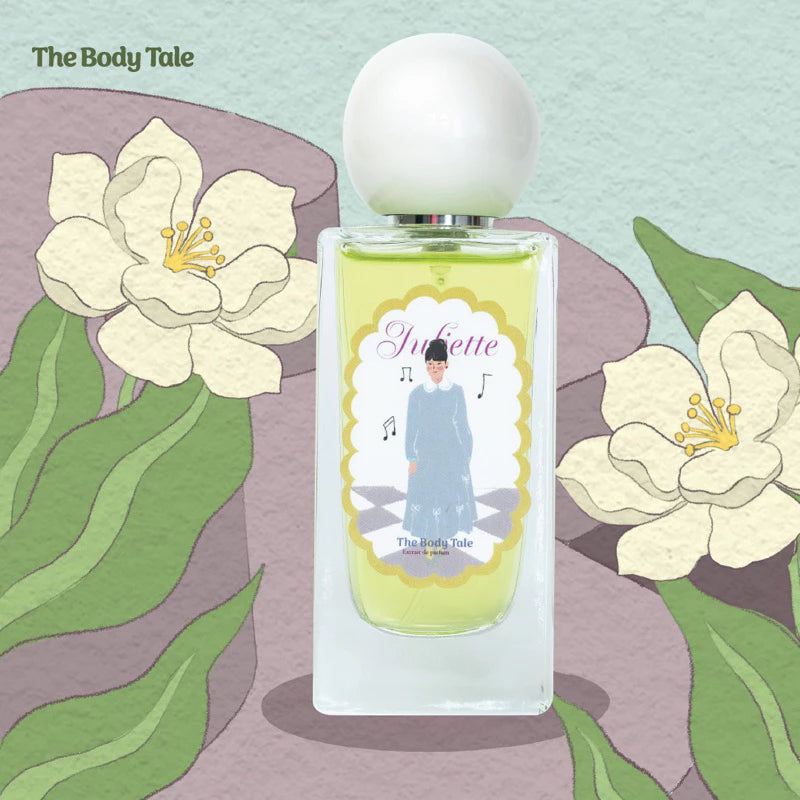 Perfume bottle labeled 'Juliette' and 'Extrait De Parfume' by The Body Tale with a nature-themed background