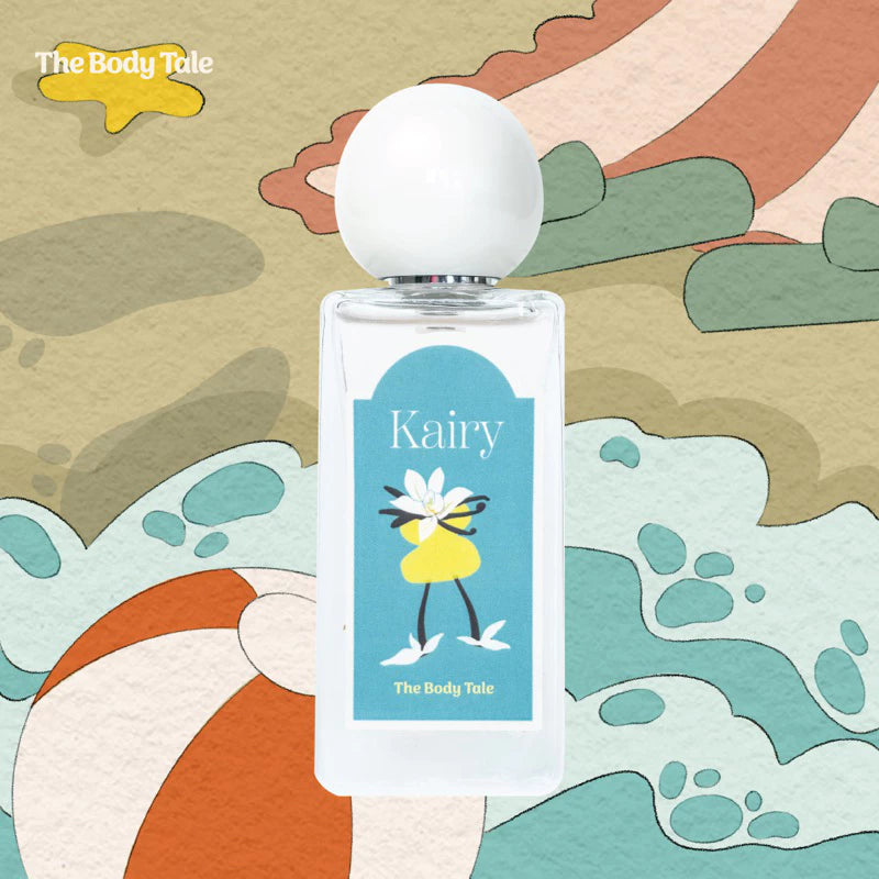 A bottle of Kairy perfume by The Body Tale with a beach-themed background.