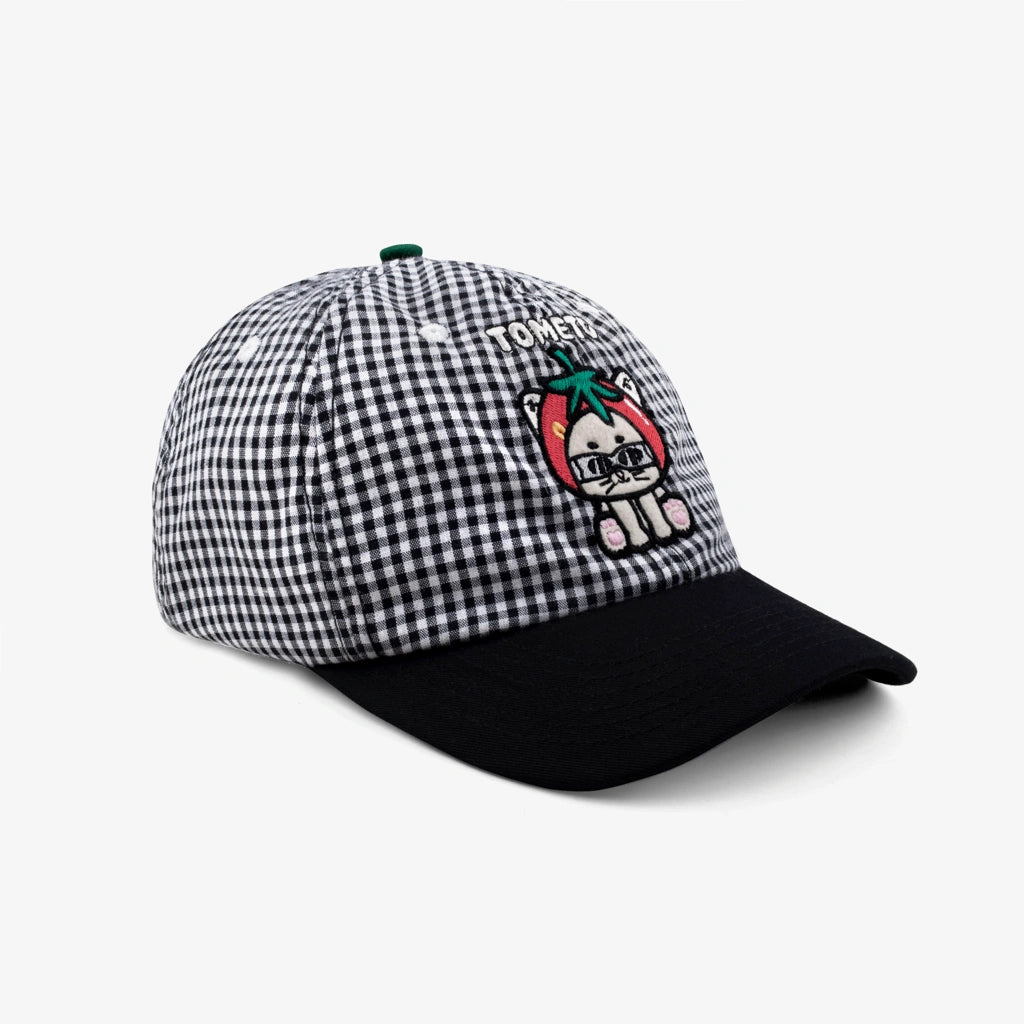 Checkered cap by Tome Ame with cartoon character on a white background