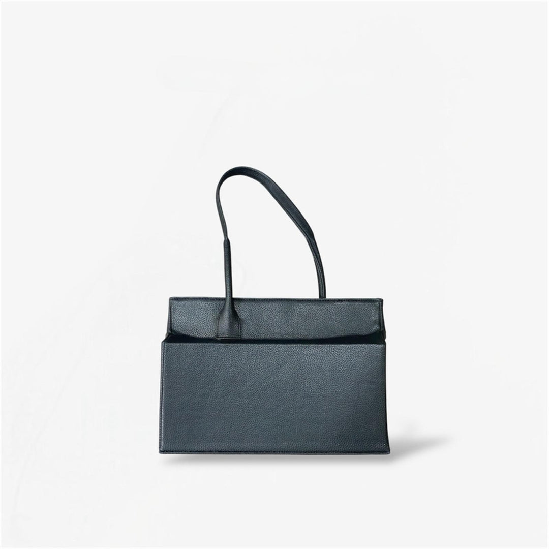 Black leather shoulder bag from Masagi on a light gray background