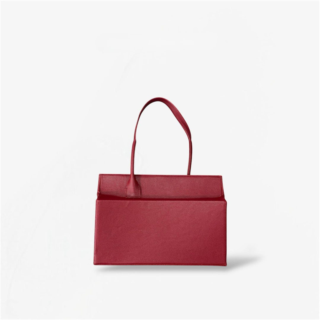 Dark red leather shoulder bag from Masagi on a light gray background
