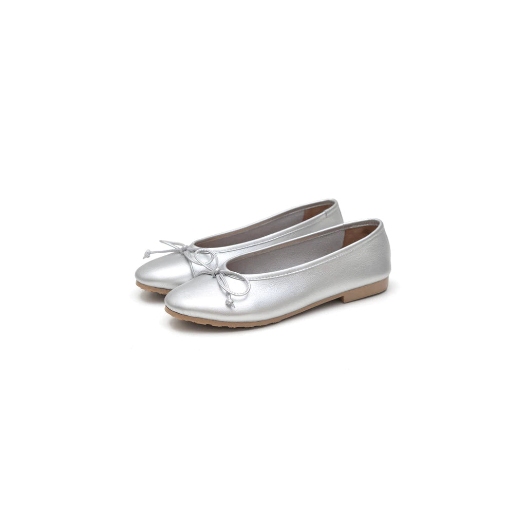 Pair of silver flat shoes by Cajsa on a white background