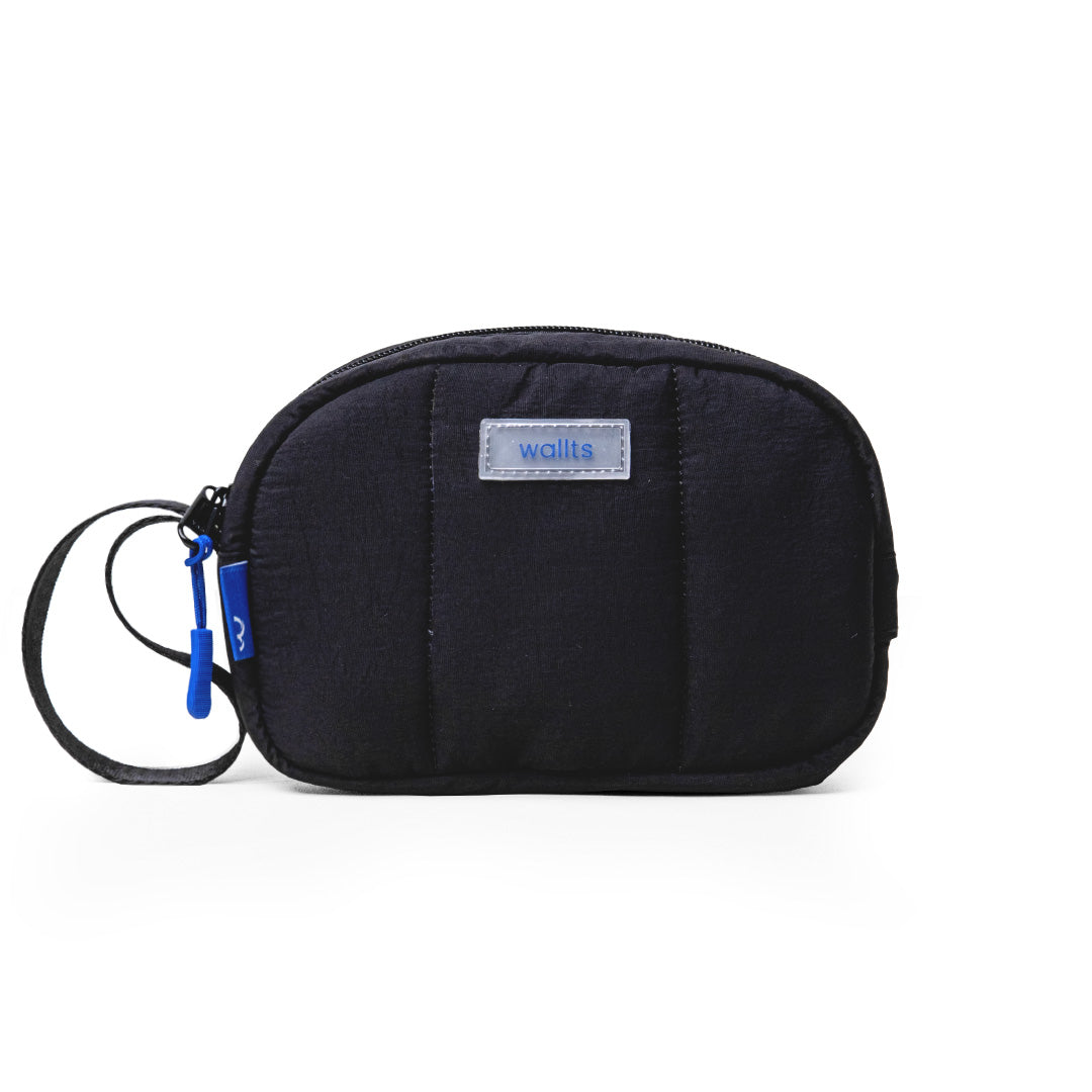 A black Muuji pouch with a blue wristlet strap, made from water repellent nylon material, with a label showing the brand Wallts.