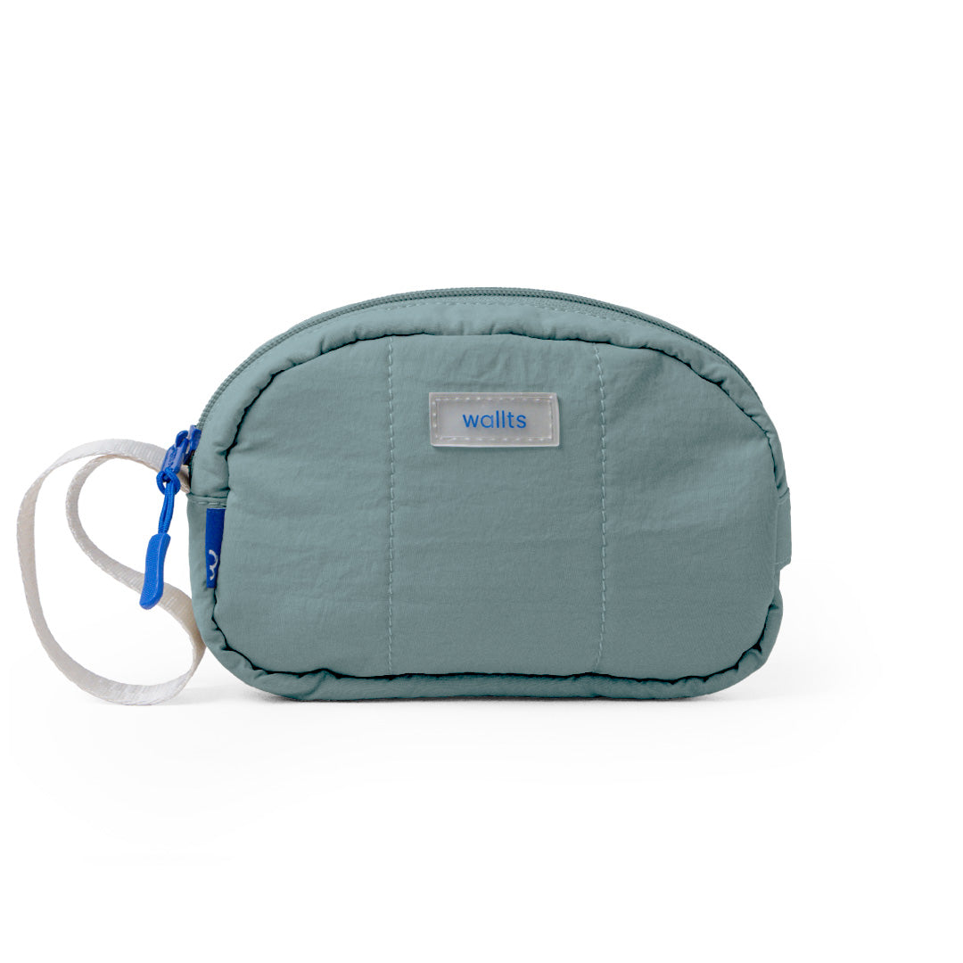 A sage green Muuji pouch with a blue wristlet strap, made from water repellent nylon material, with a label showing the brand Wallts.