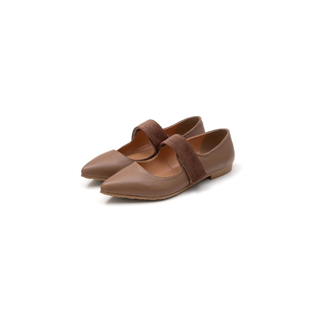 Pair of brown pointed-toe flat shoes with a strap on a white background