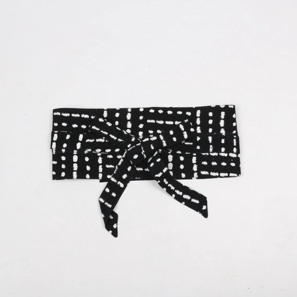 A black obi belt with a geometric pattern, made of rayon, tied in a bow.