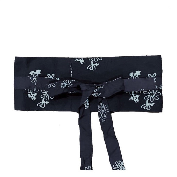 A traditional black Obi Belt with a floral pattern in brown, made of rayon, tied in a bow.