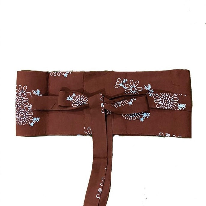 A traditional terracota Obi Belt with a floral pattern in brown, made of rayon, tied in a bow.