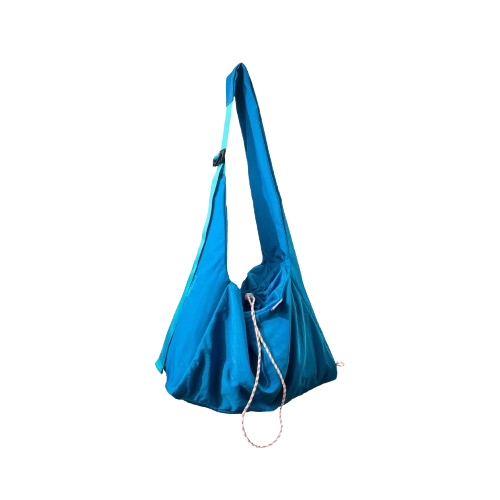 Blue crossbody bag by Measure Pleasure with a strap on a white background