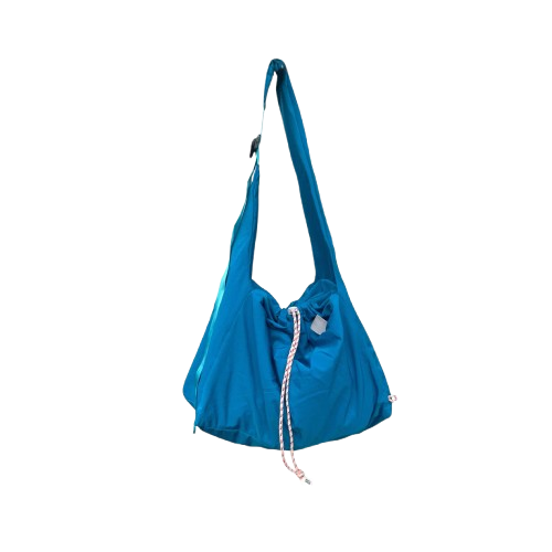 Blue crossbody bag by Measure Pleasure with drawstring on a white background