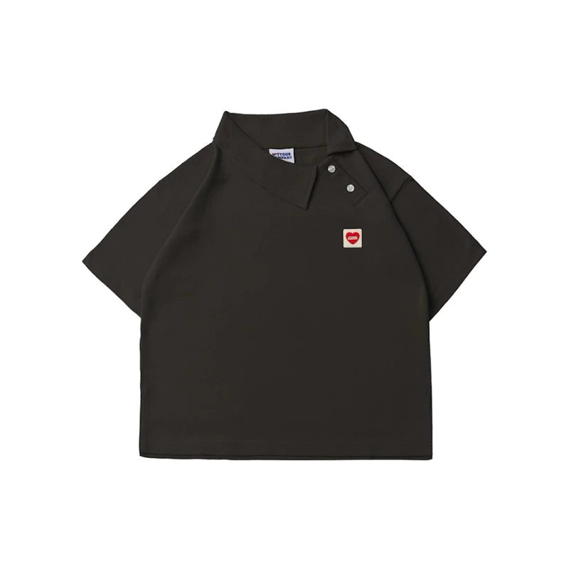 Dark grey polo shirt with a small red heart logo by notyourcompany on a white background