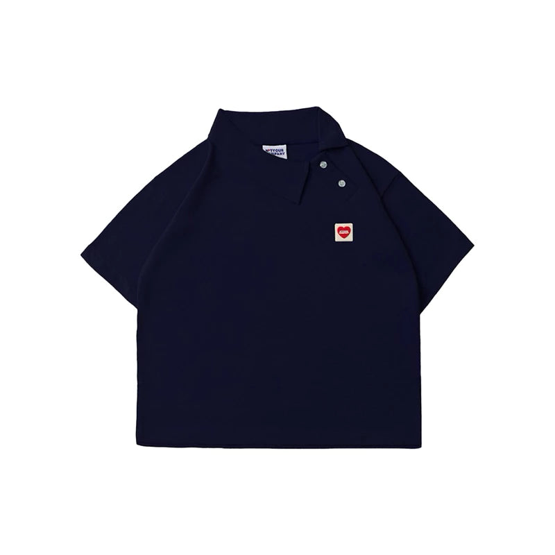 Navy polo shirt with a small red heart logo by notyourcompany on a white background