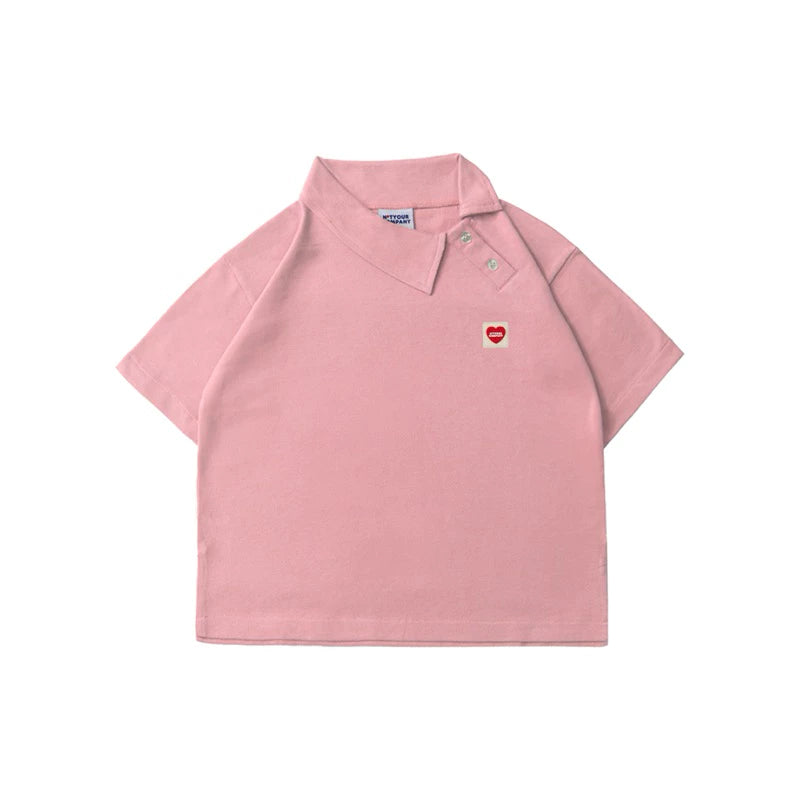 Pink polo shirt with a small red heart logo by notyourcompany on a white background