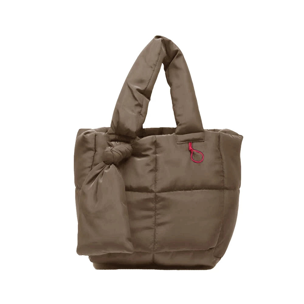 Brown puffer handbag by Hunting Fields with a red details on a white background