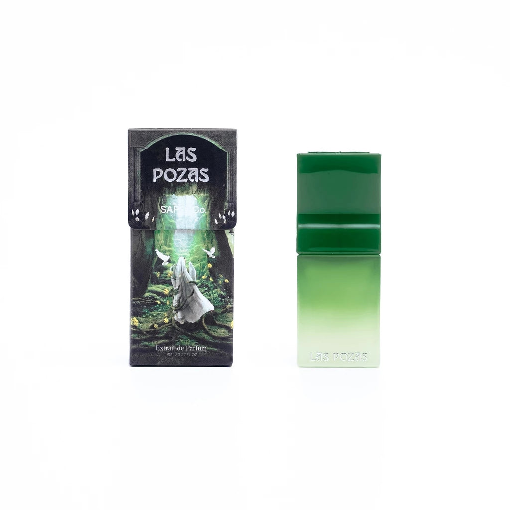 A travel-sized bottle of Saff & Co. perfume named 'Las Pozas' with a green cap, displayed next to its packaging.