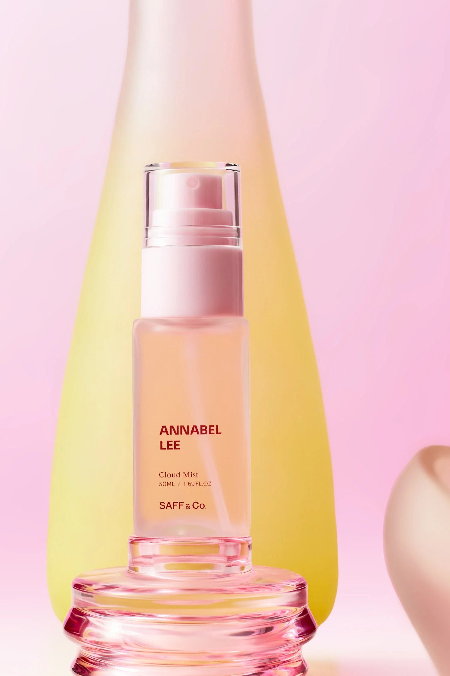 Pink body mist bottle with 'ANNABEL LEE' text by Saff & Co on a pink background