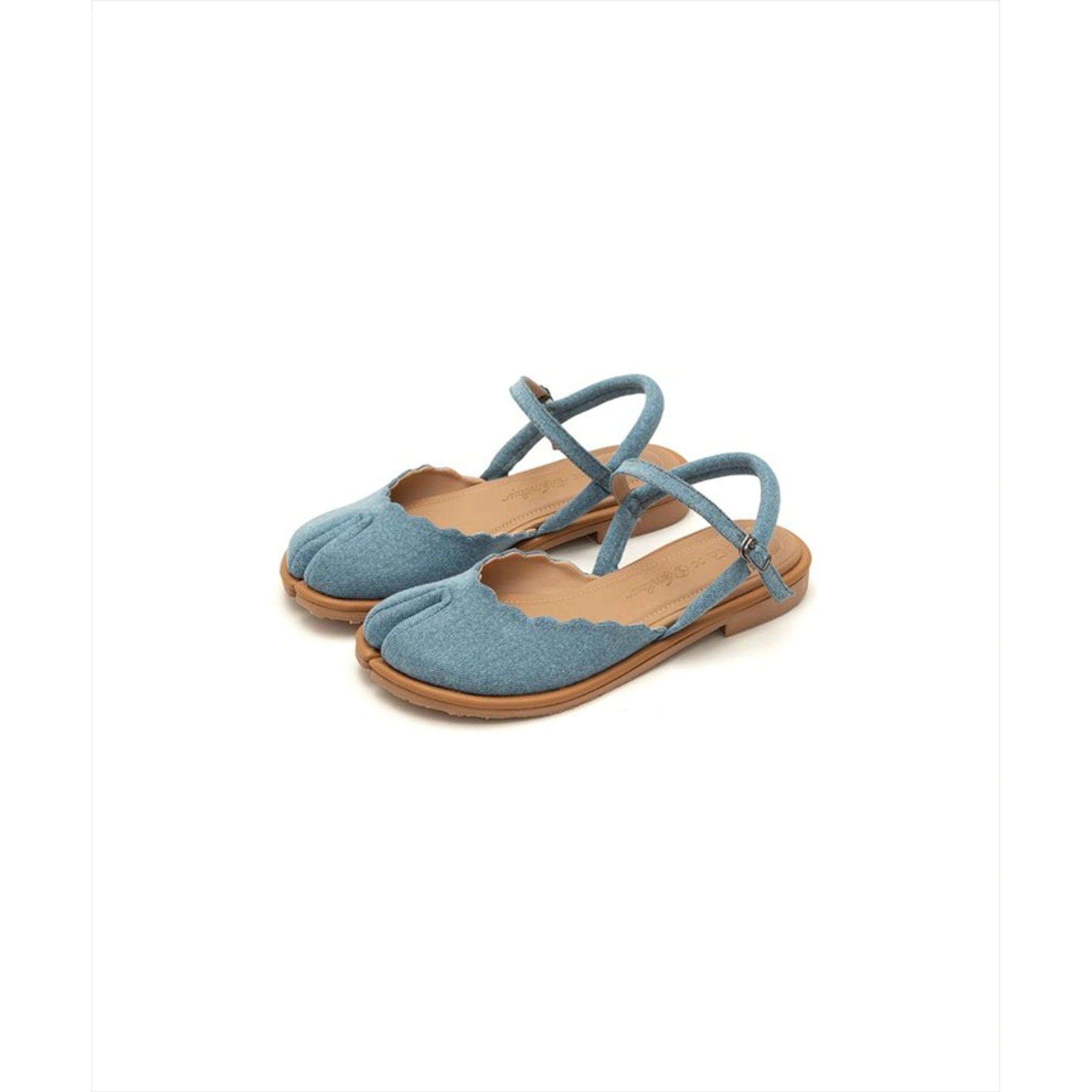 A pair of blue denim tabi flatshoes with scallop edge detail and ankle straps.