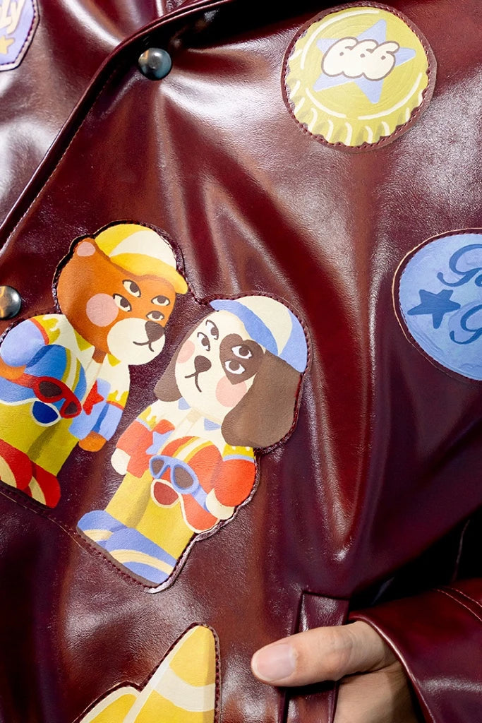 Close-up of a maroon leather jacket with colorful patches featuring cartoon characters by oh.irv.