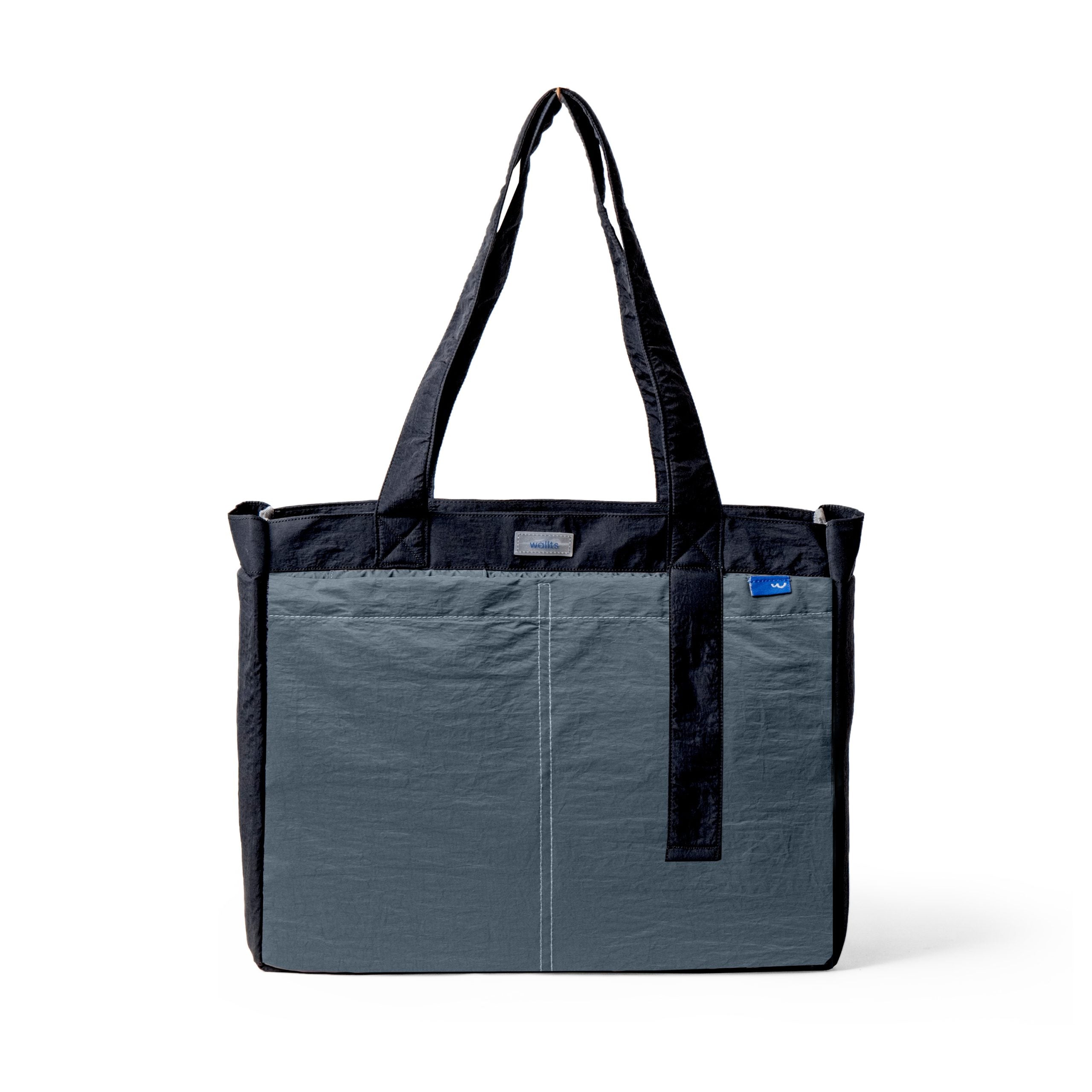 A gray and black colored 2-in-1 tote bag by Wallts that can also be used as a backpack, made of crinkle material, with multiple compartments including a laptop sleeve and a tablet sleeve.