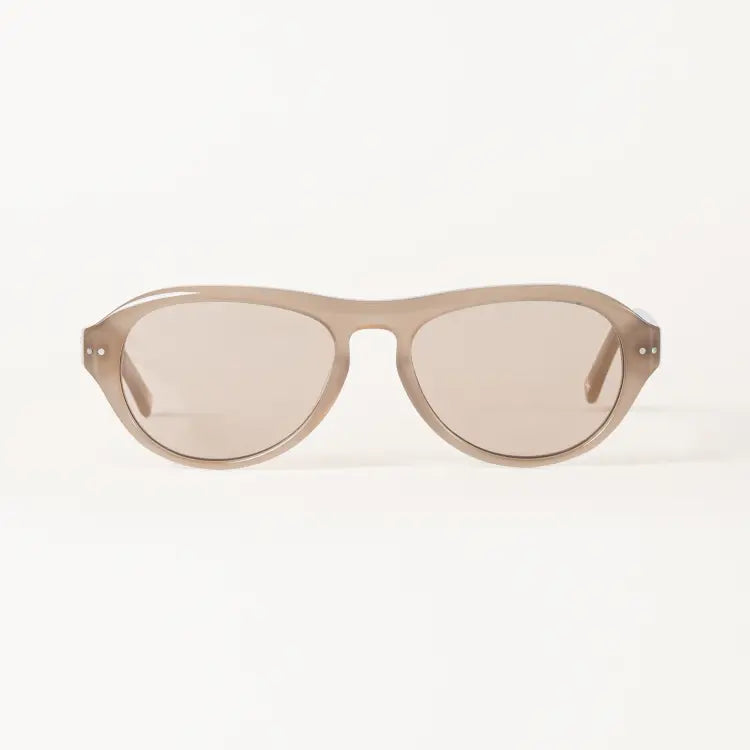 Oversized sunglasses by Heykama with a translucent taupe frame and matching tinted lenses, shown against a clean white background.