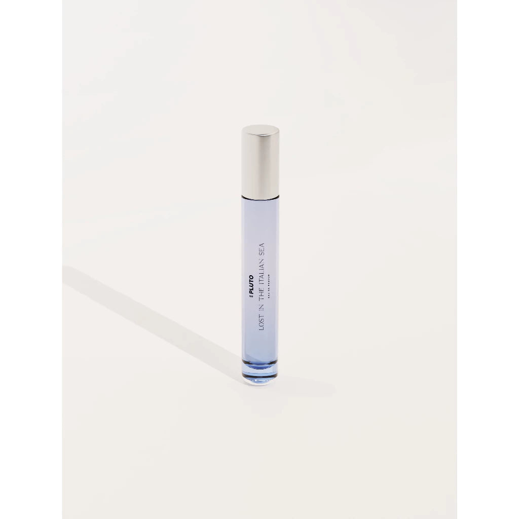 A travel size Lost In Italian Sea perfume from Scents Of Pluto with a clear body and white cap against a white background.