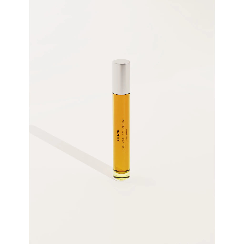 A travel size of The Vanity Room perfume from Scents Of Pluto with a clear body and white cap against a white background.