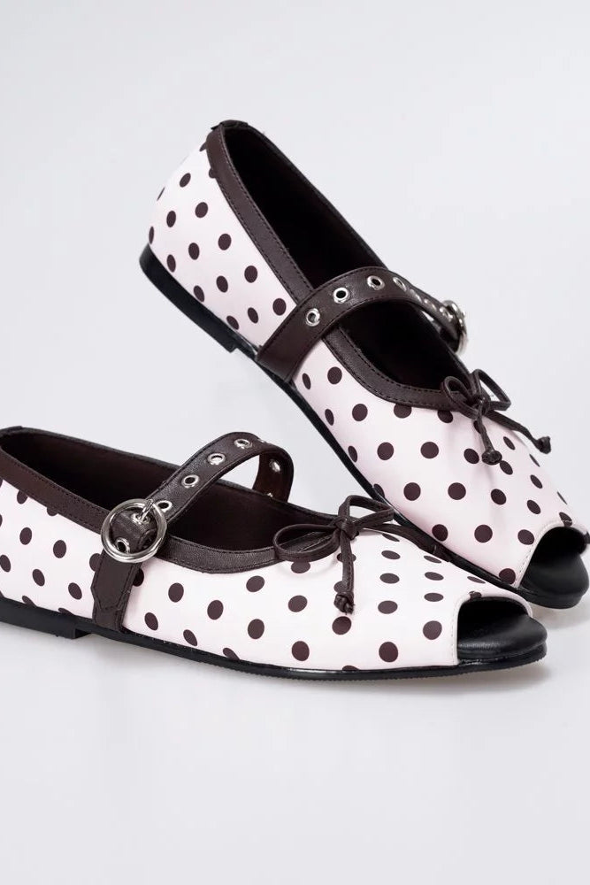 A pair of women's peep-toe flatshoes by Mar & Ma with a pink base covered in dark brown polka dots, featuring dark brown straps with silver-tone metal buckles and bows, set against a light gray studio background.