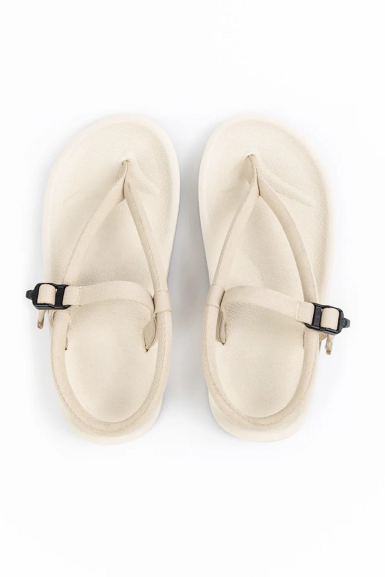 A pair of off-white thong sandals by Gahalu with adjustable straps and black buckles, shown from a top-down view on a white background.