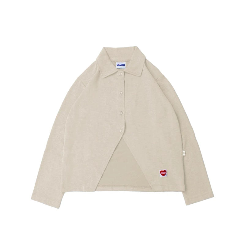 Cream-colored shirt with a red heart patch by notyourcompany on a white background